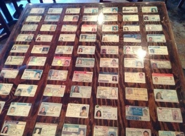 Bar decorates their tables with seized fake IDs.