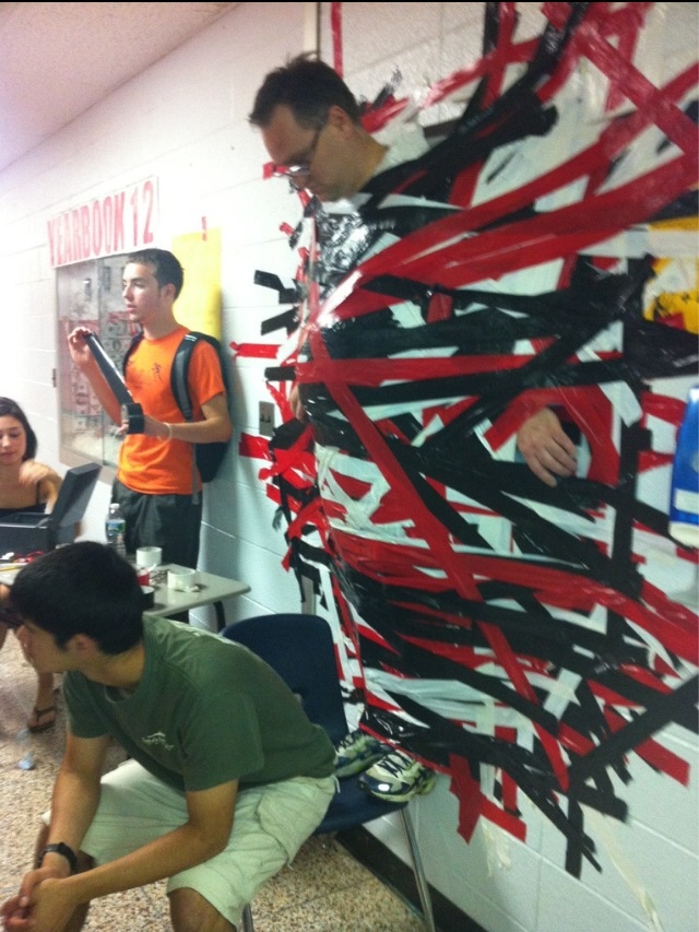 Students tape principal to wall for school fundraiser