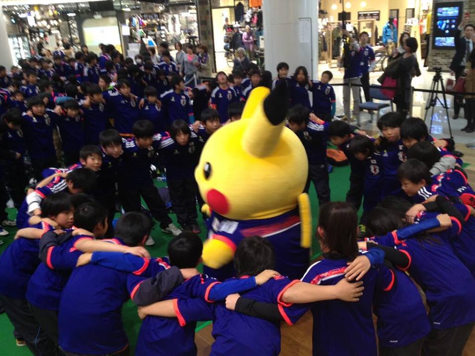 Japanese people praying and summoning Pikachu before the battle...I mean, football game