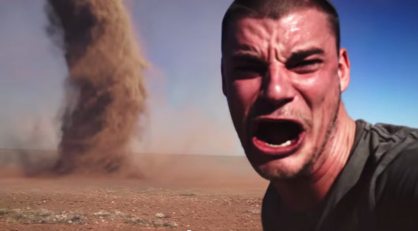 Crazy Australian Man takes photo in front of Outback Tornado.