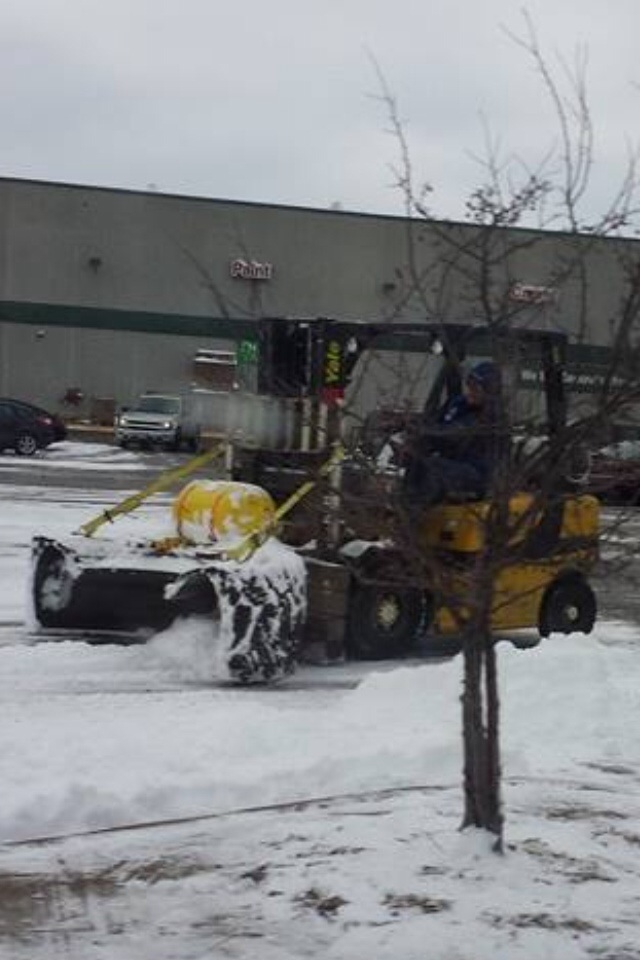 Only in Wisconsin. Plowing with a forklift and half a tire.