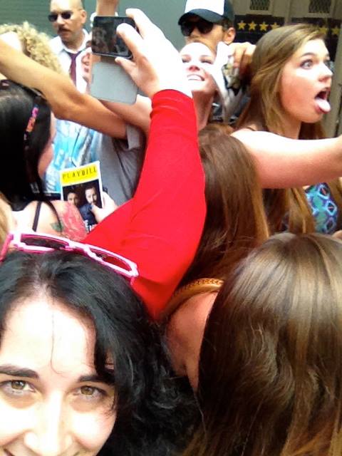 A mob of chicks trying to take selfies with James Franco