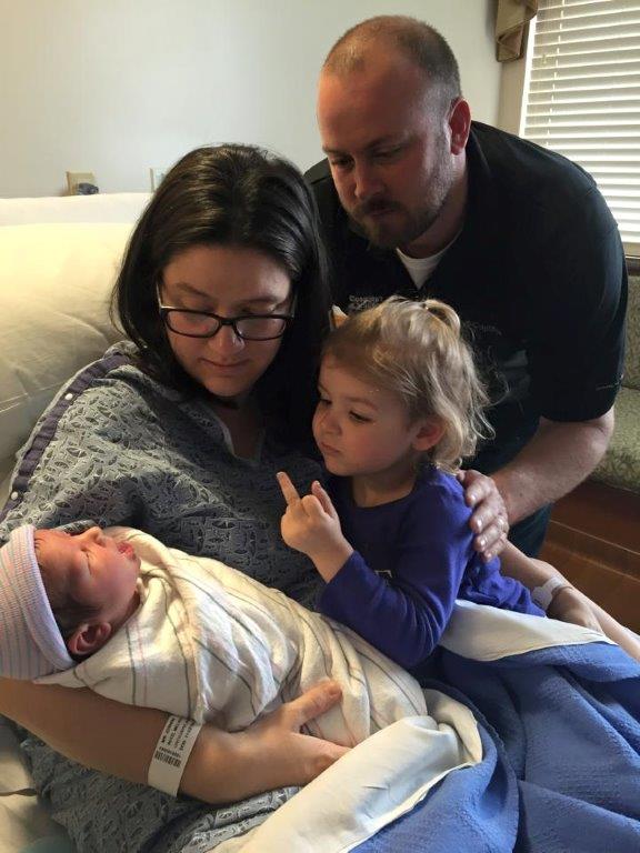 Sister welcomes newborn sibling to the family.