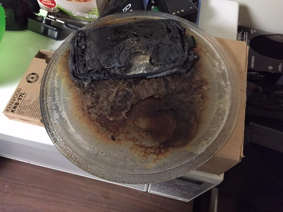 A guest put it in the hotel microwave to give it "a quick charge." Fire alarm followed.