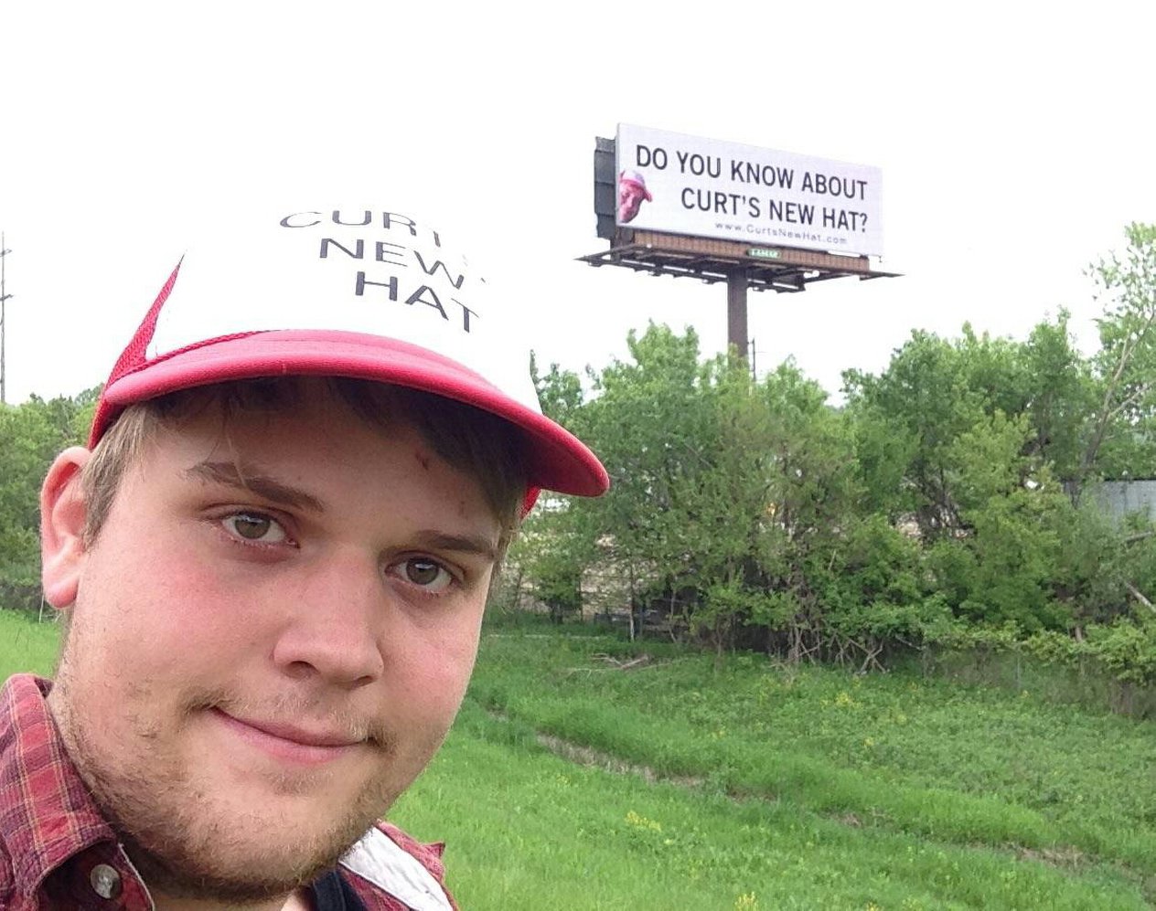 Old schoolmate buys a billboard showing his new hat