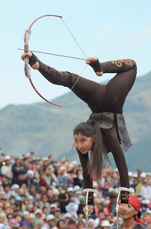 PsBattle: Shooting her bow upside down on forearm crutches, with her toes. From the World Nomad Games