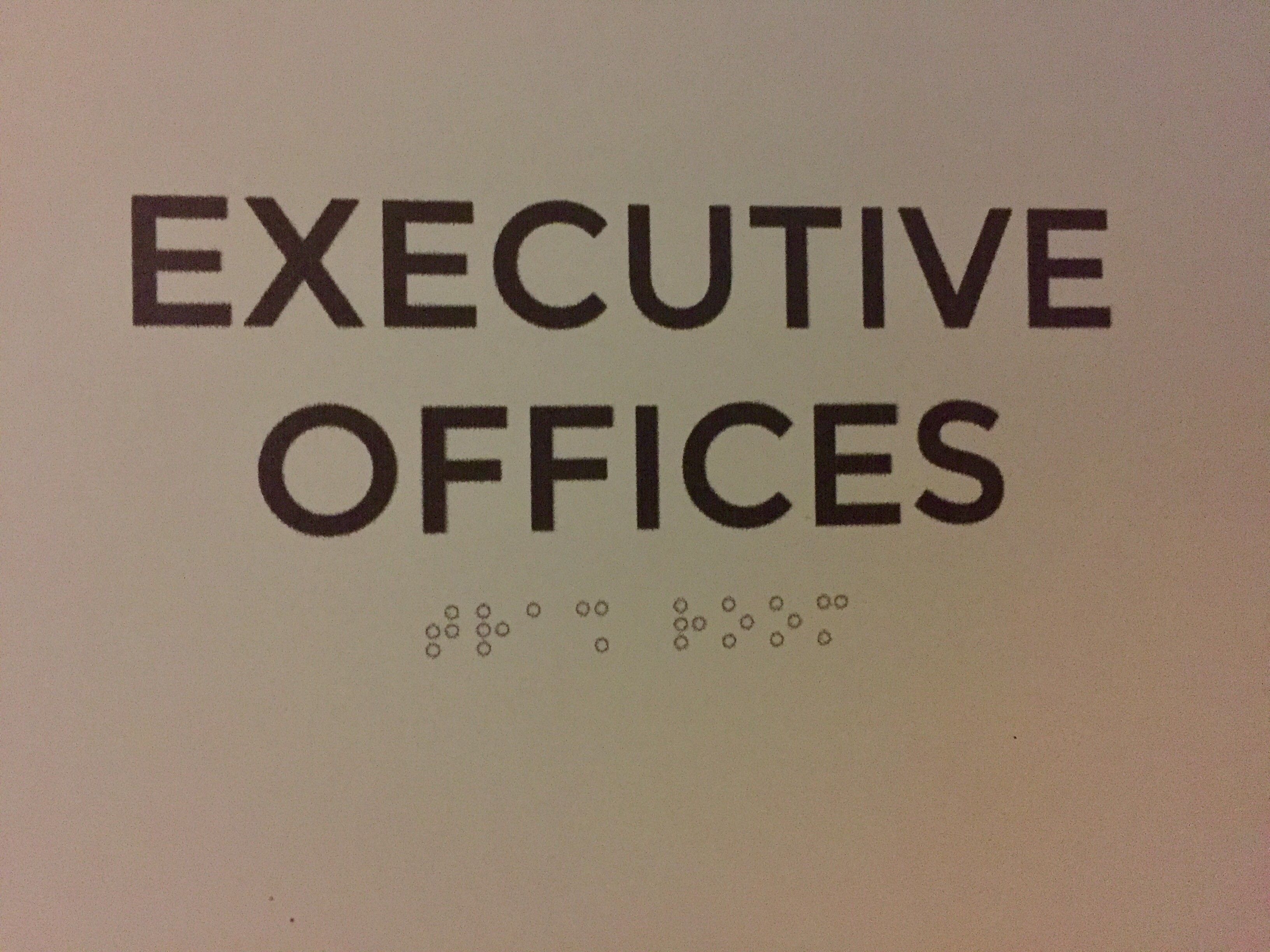 The braille on the "Executive Offices" sign outside where I work is both flat and says "Trash Room"