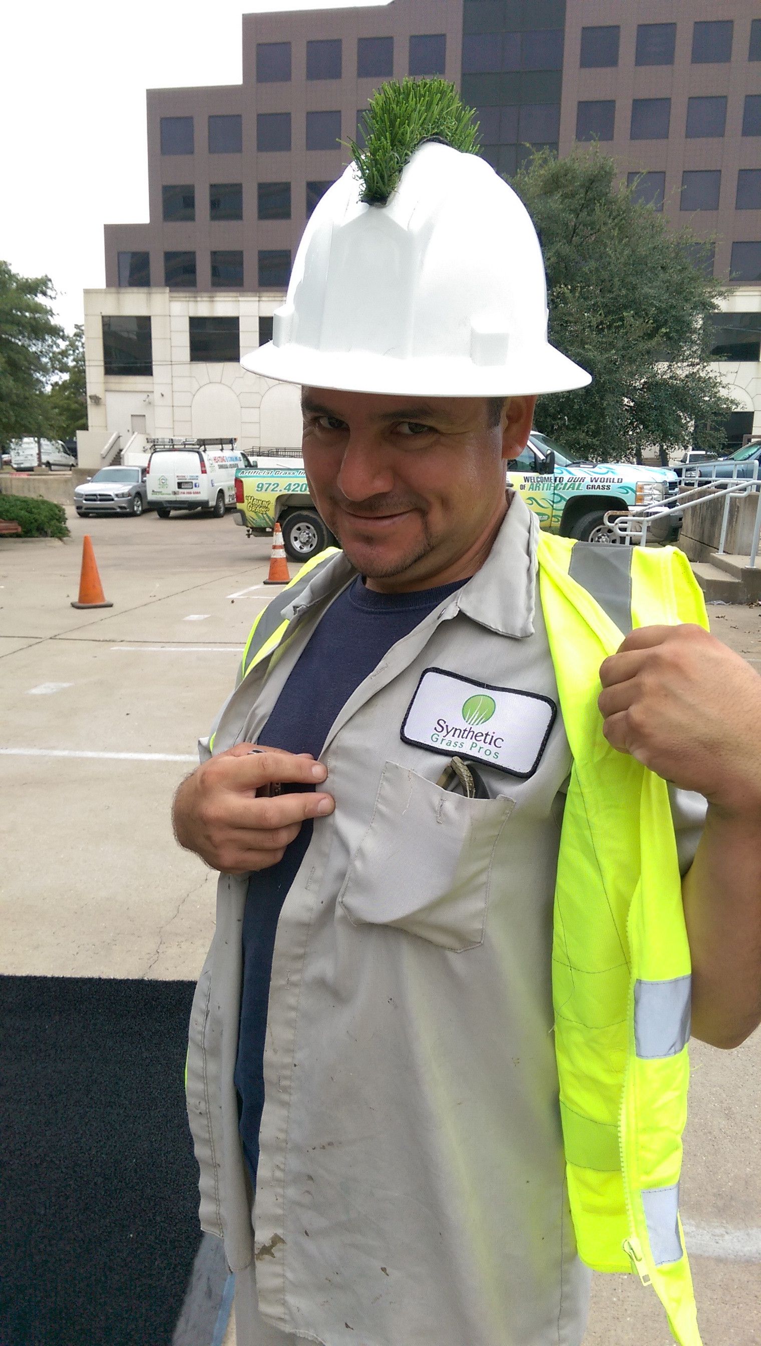 Worker who installs astroturf gave himself a fake grass mohawk on his hardhat.