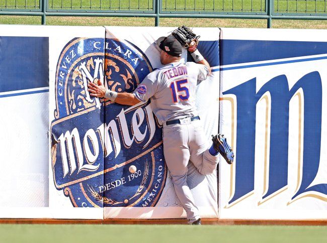 Tim Tebow smashes into outfield wall