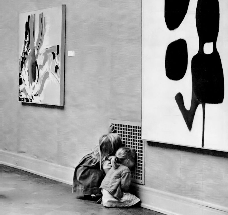 Two girls more engrossed with the air vent grate than the modern art on the walls of the San Francisco Museum of Art, 1963.