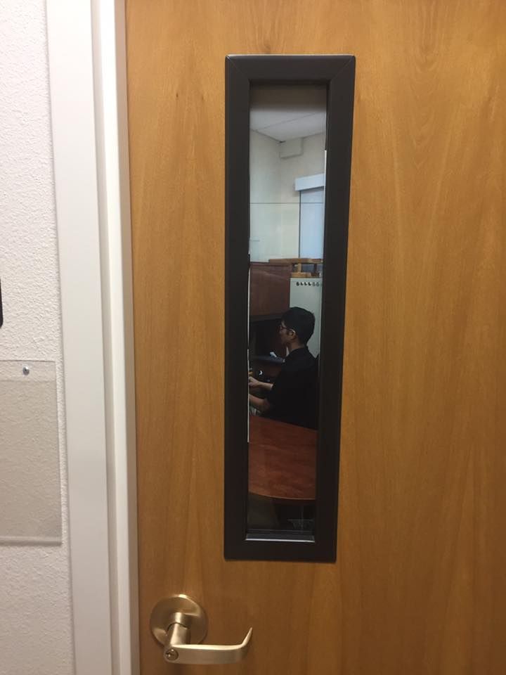 Professor at my local university has photo of him sitting at his desk on the window.