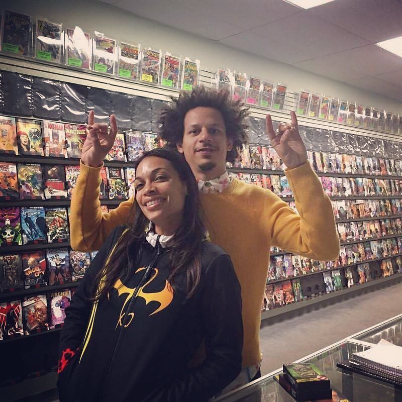Rosario Dawson wearing Iron Fist Jacket and Eric Andre in comic shop.
