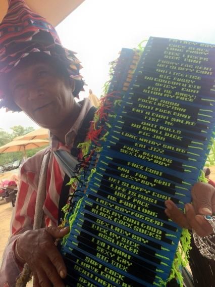Man selling "friendship bracelets" on the beach in Thailand.