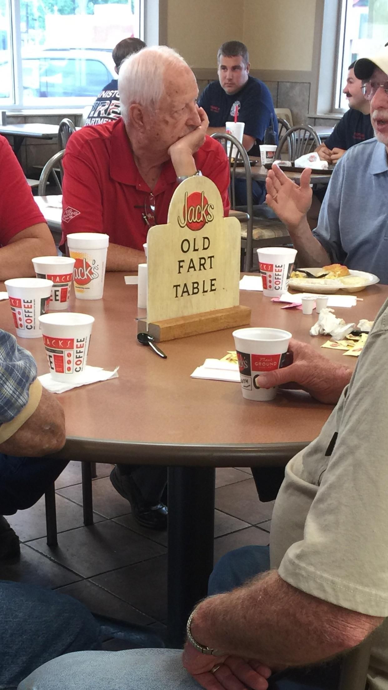 These guys sit at this table every morning. The restaurant owners made this sign to claim the table for them.