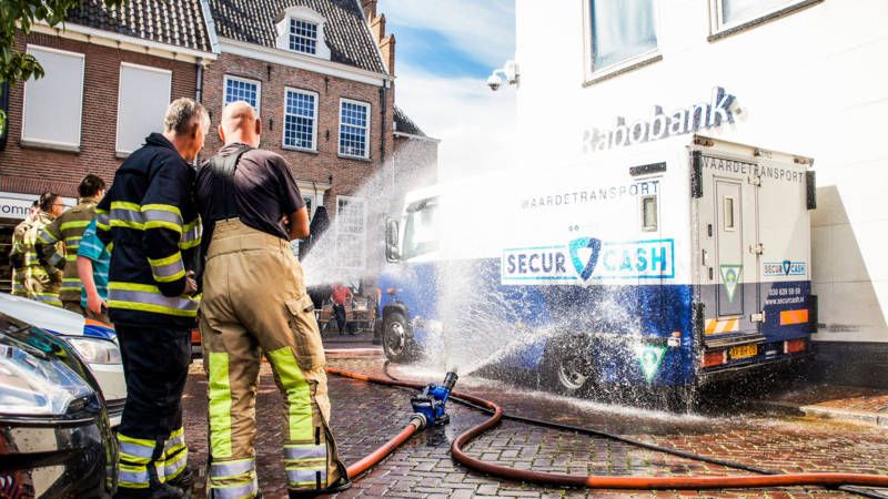 Two Dutch guys stuck in money transport truck in the sun having to be cooled by the fire department until someone who can open it arrives