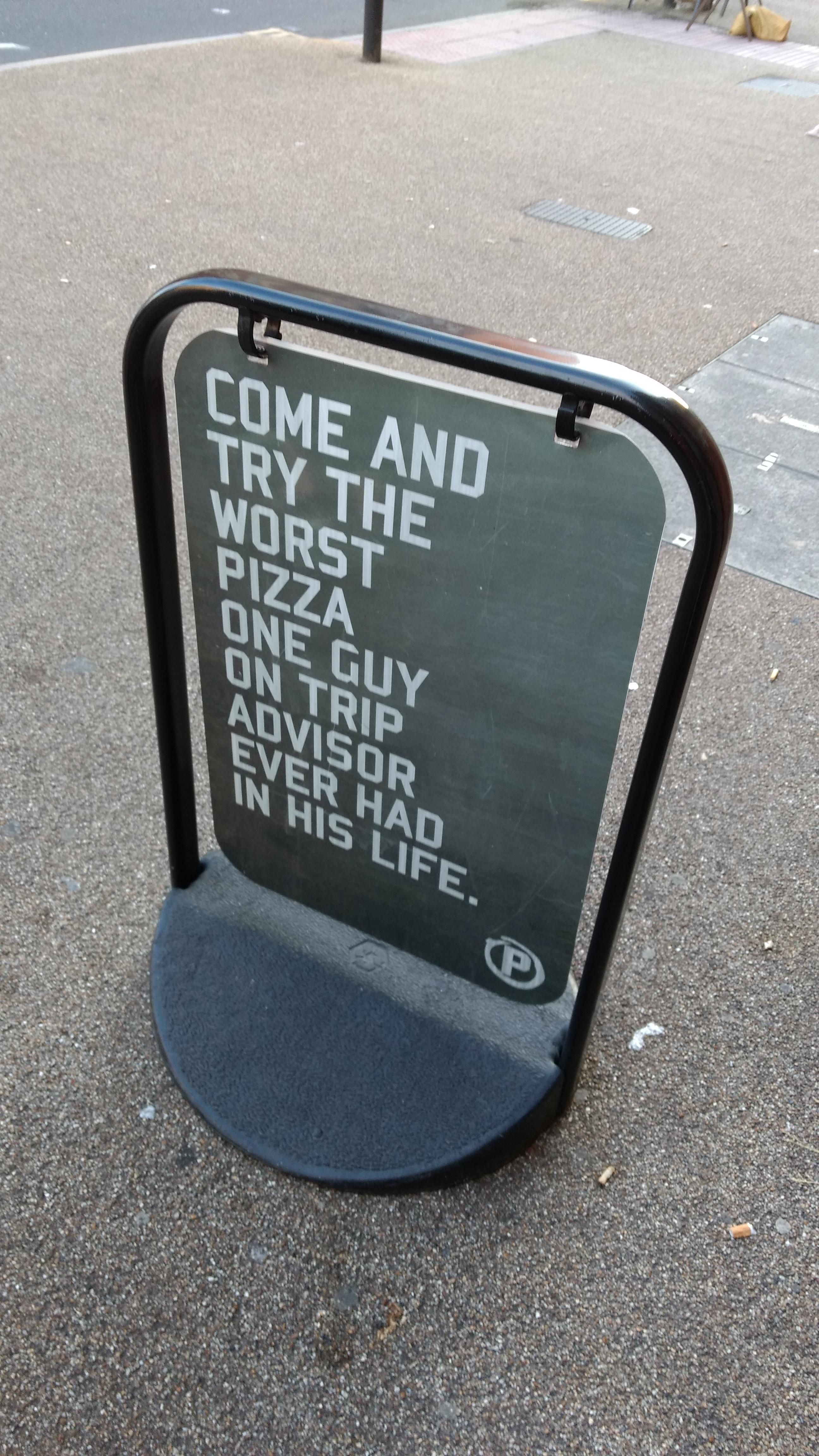 This sign at a pizza restaurant.