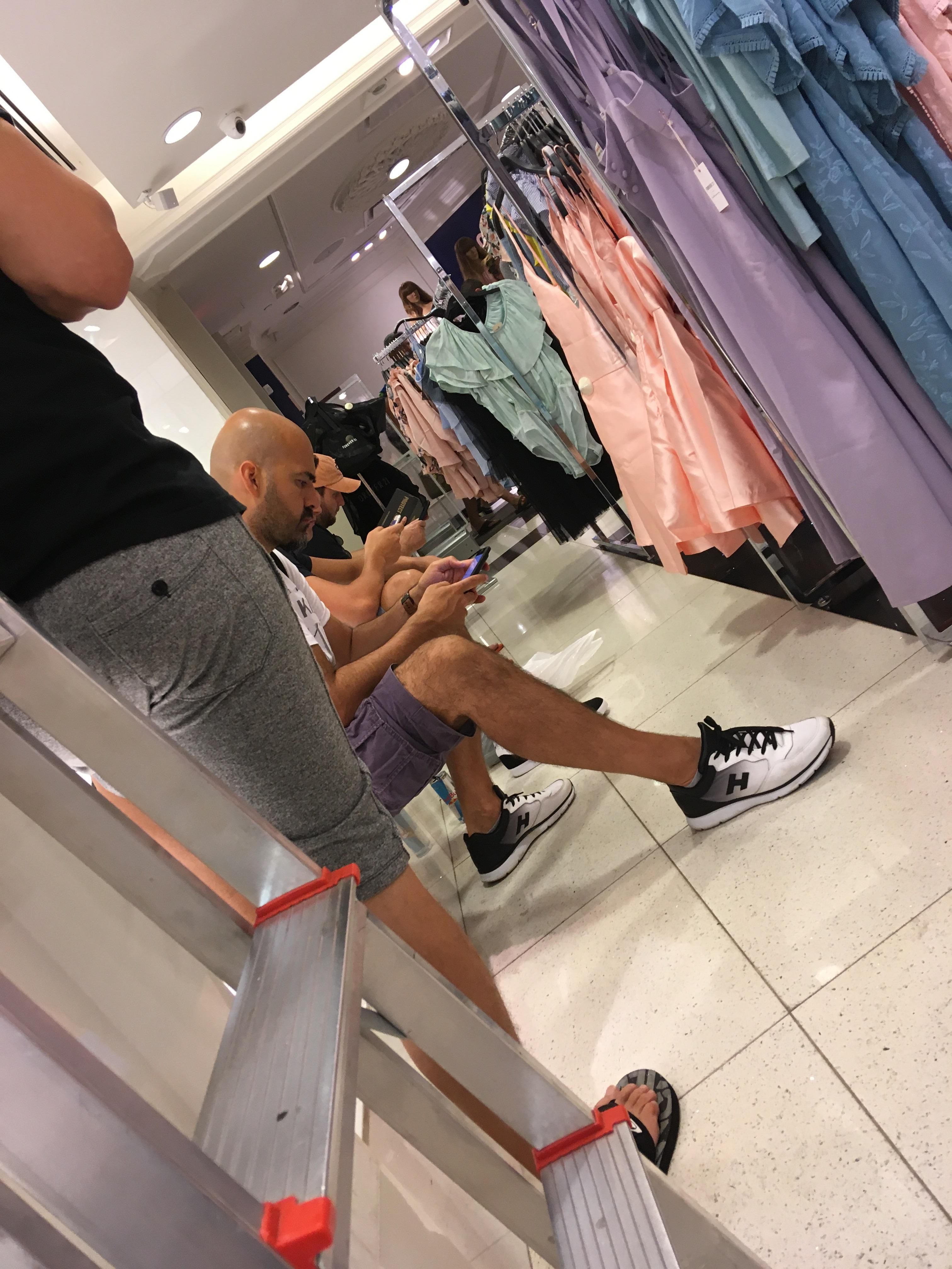 I'm sitting in a forever 21 store with five other men just waiting...