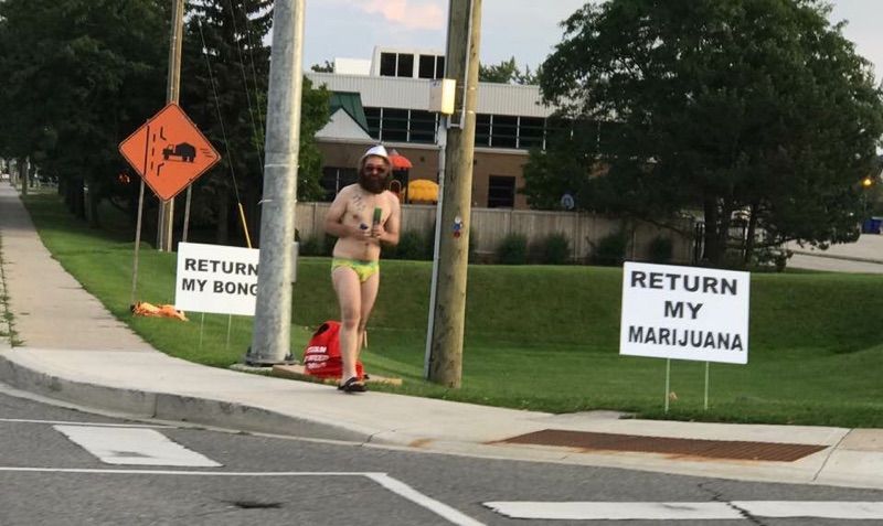 Saw this guy biking downtown a week ago in a Speedo, smoking a bong. This is him protesting outside the police department