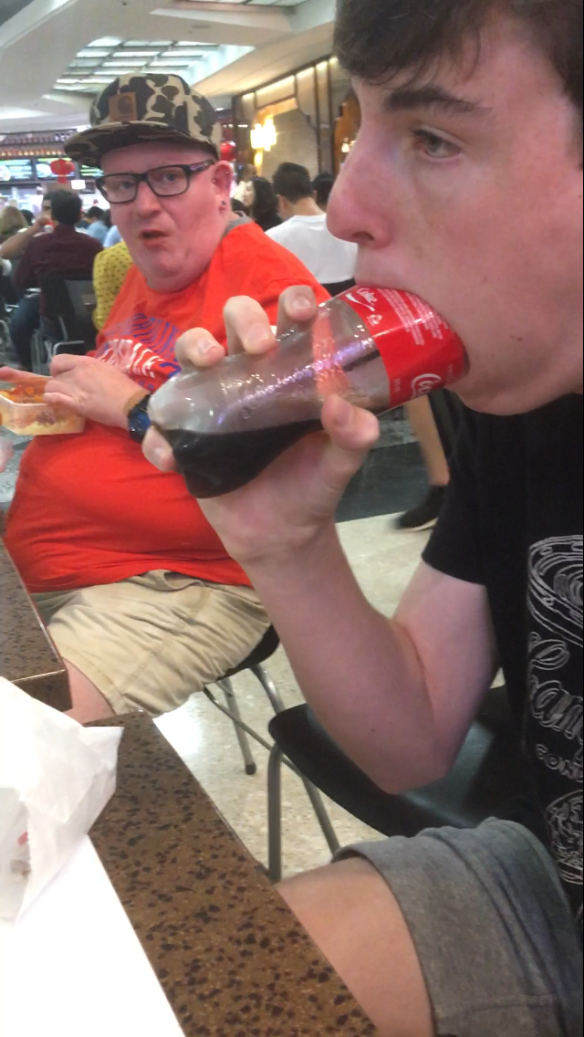 My friend deepthroating a coke bottle in public