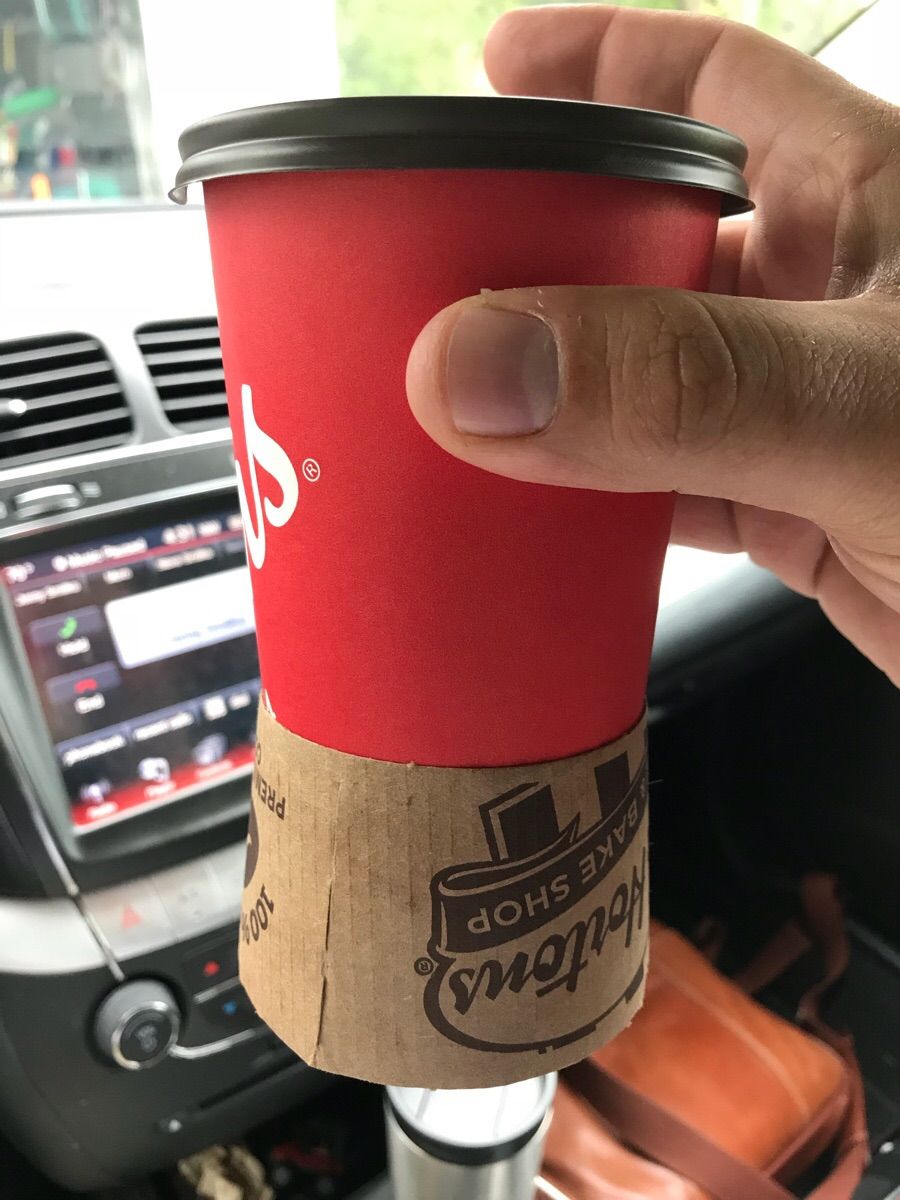 So I stopped at a Tim Hortons Roseville, MI...And watched the cashier struggle to put the sleeve on my coffee. Eventually, he just gave up and gave it to me like this.