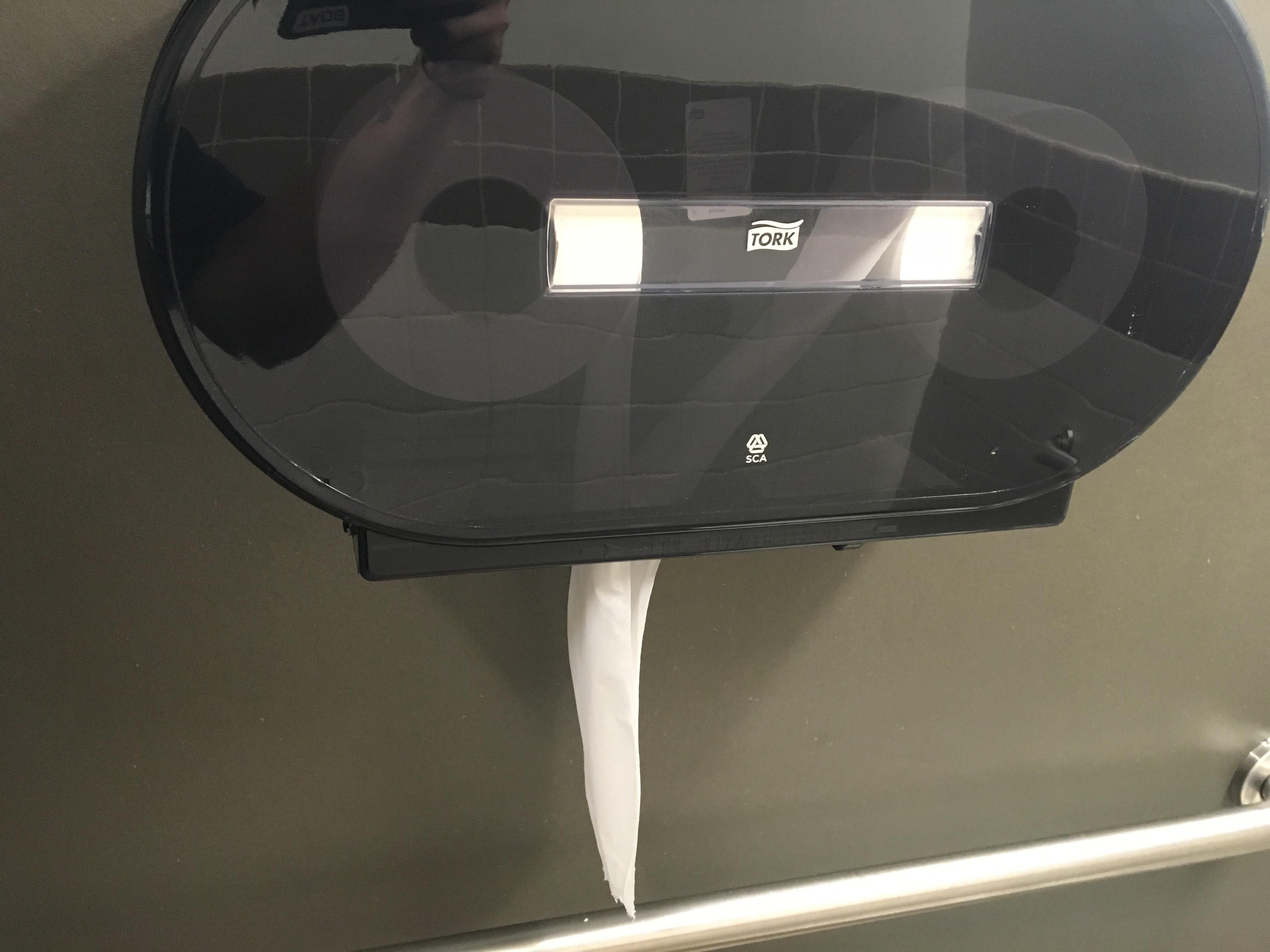 Someone rigged this toilet paper dispenser to make it two ply