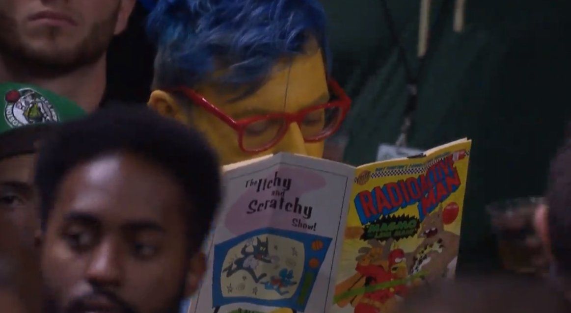 Someone went to the Celtics/Bucks game as Milhouse from the Simpsons and read a Radioactive Man comic during every timeout. Now that's commitment.