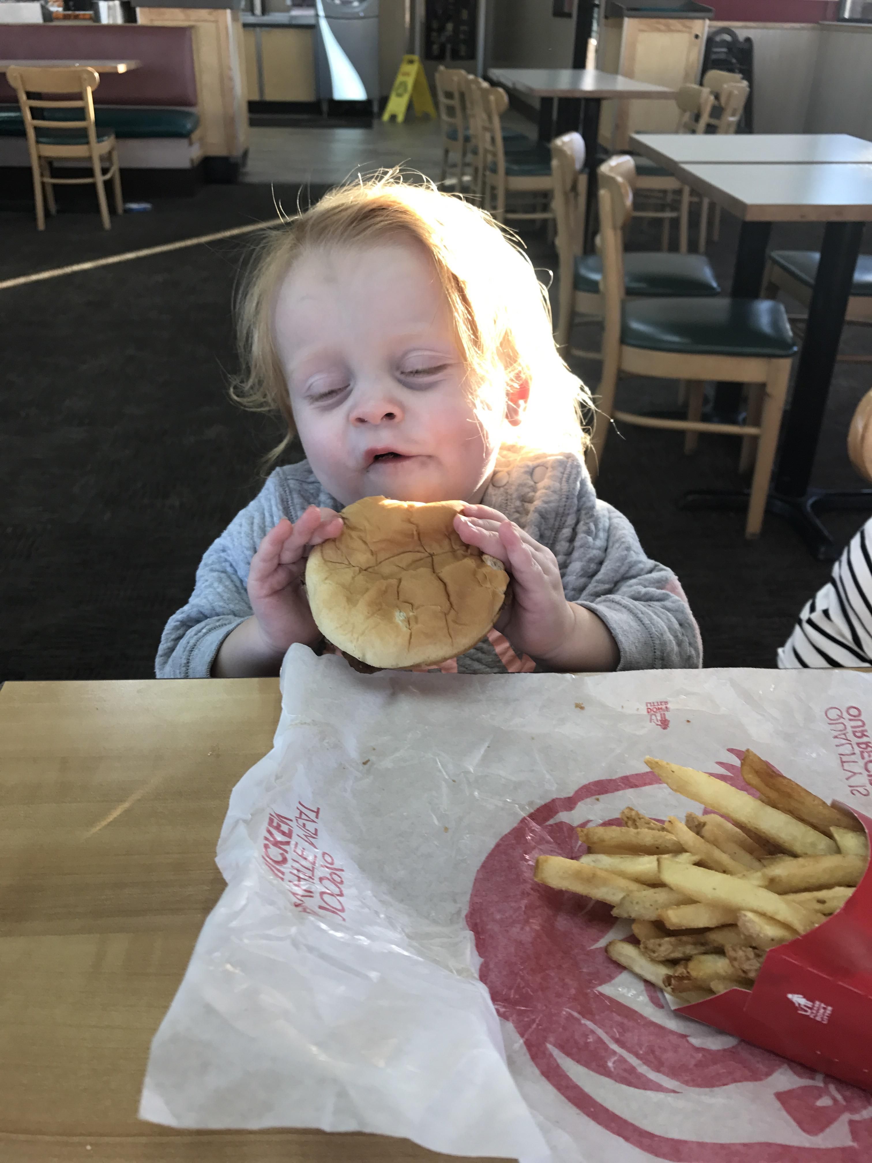 My daughter really enjoyed her first hamburger.