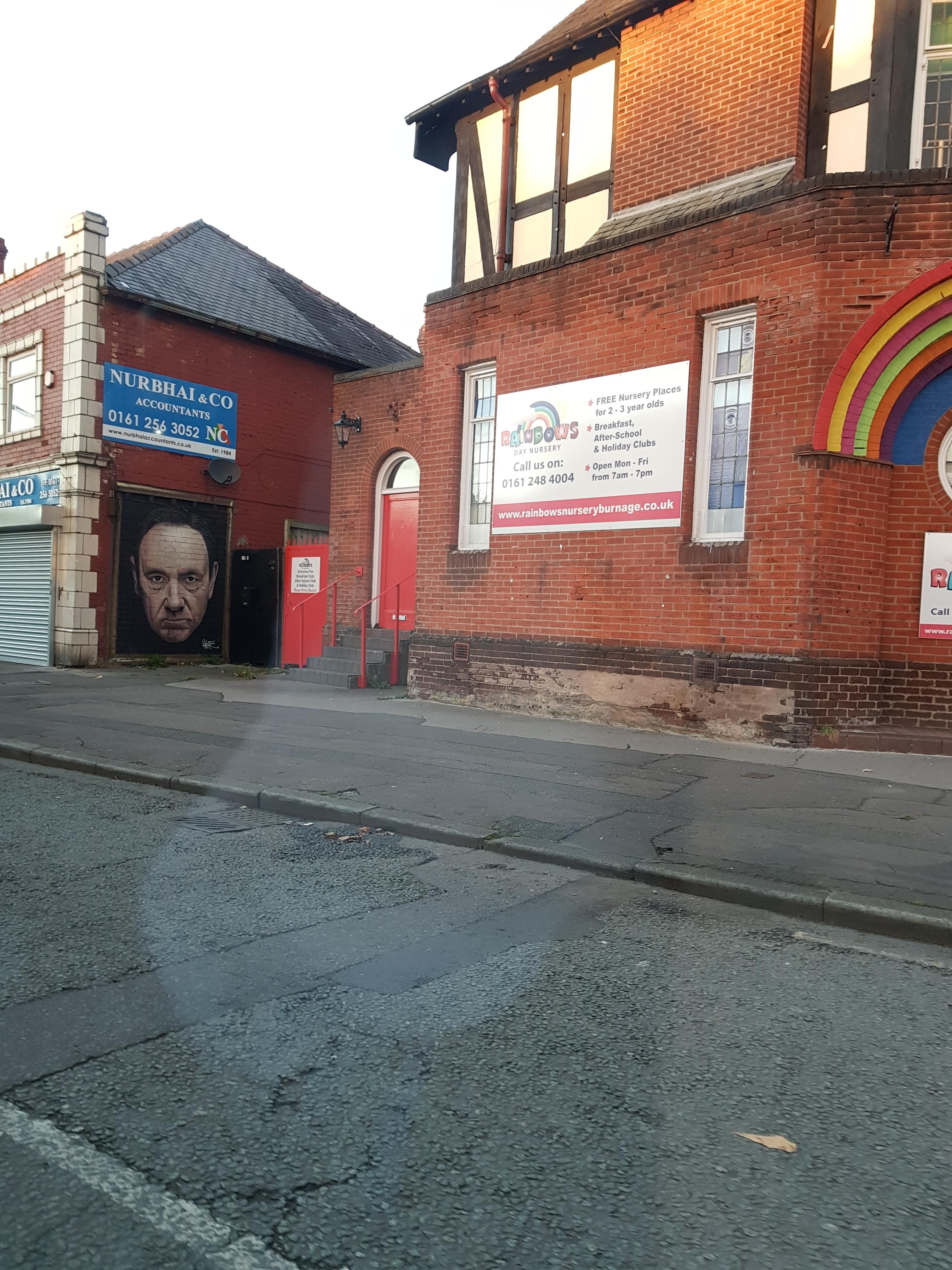 Mural to Kevin Spacey is now awfully sinister looking next to the entrance of a nursery!