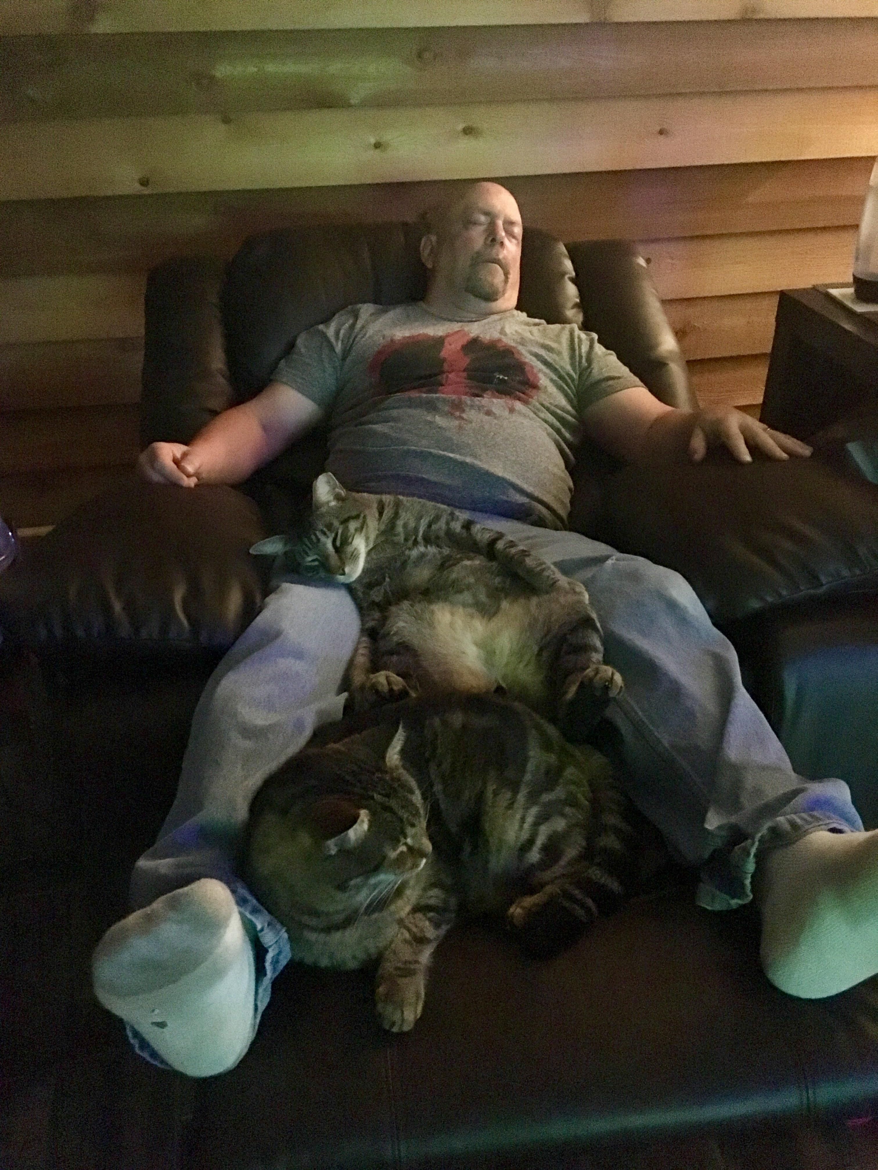 Like father, like son. Cat is sleeping in similar position to my husband. They always fall asleep together watching TV.