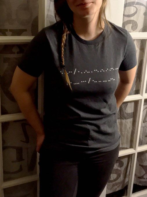 Her shirt says "New telegraph who dis?" in Morse code