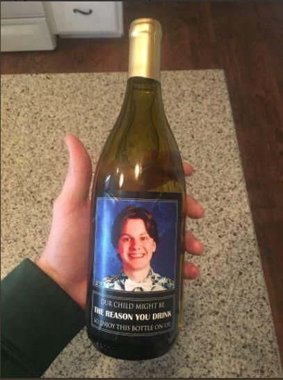 Ohio kids parents give teacher wine for Christmas with sons picture reading "Our child might be the reason you drink."