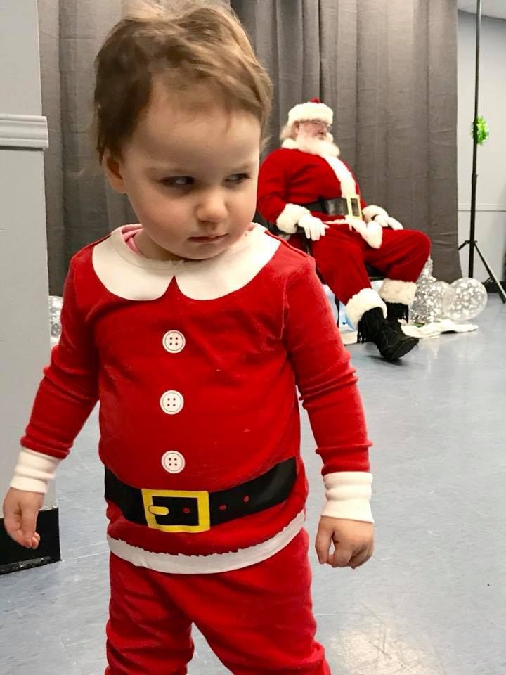 We dressed up our 18 month old daughter to see Santa. She was not pleased.