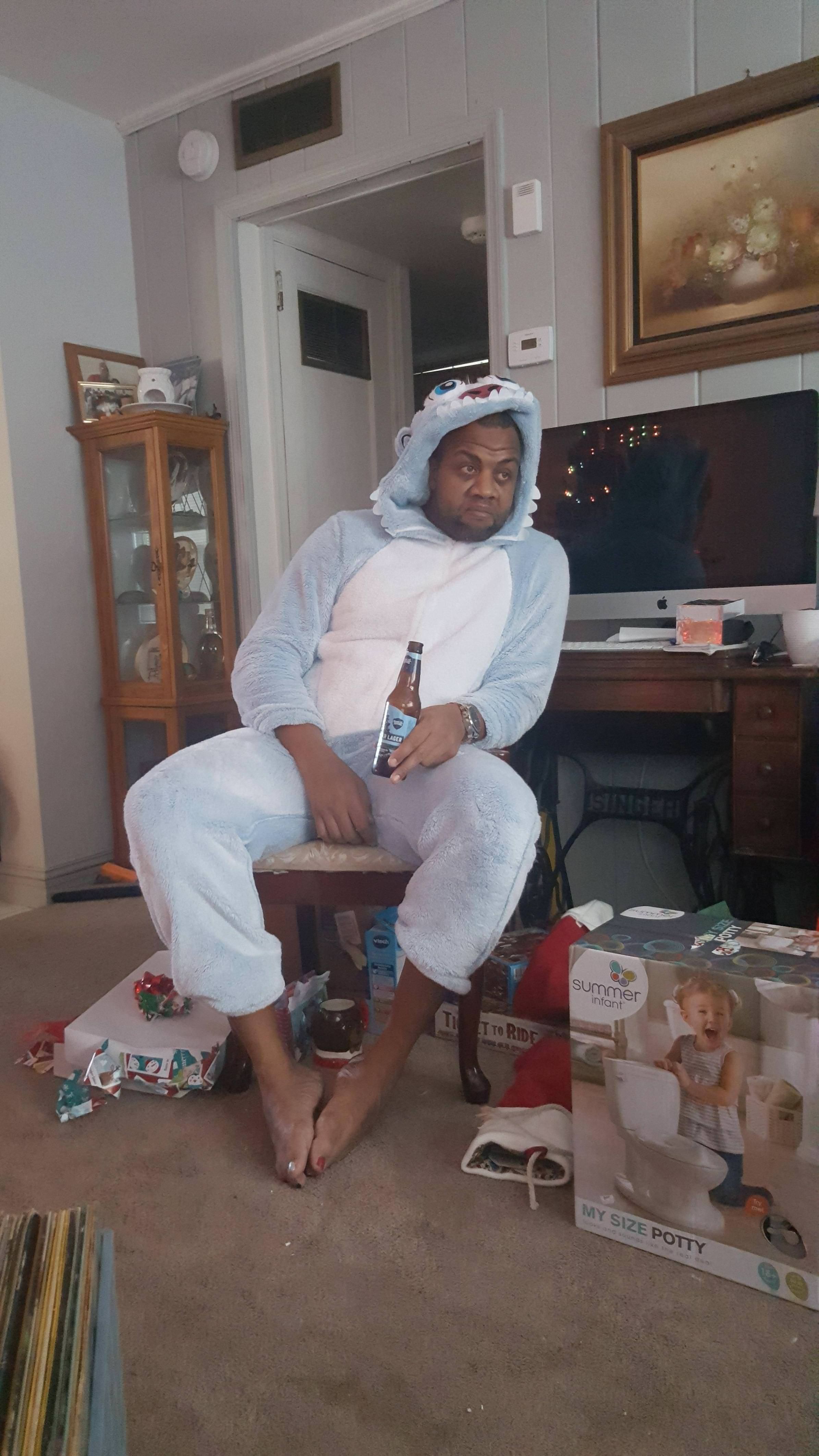My brother-in-law, who has 2 girls, taking in the aftermath of Christmas morning, wearing a Yeti Onesie that they picked out for him.