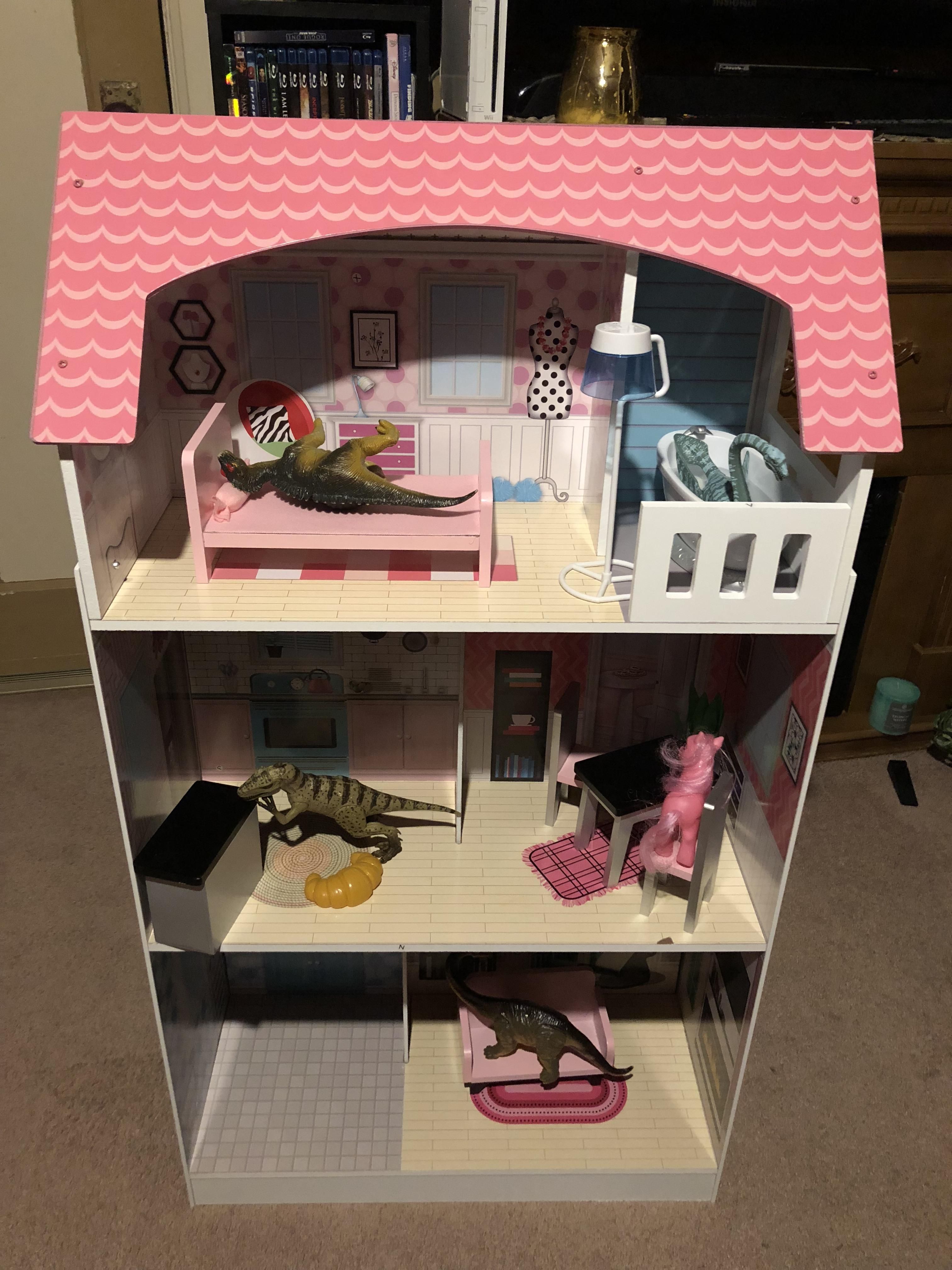 My 7 year old sister loves dinosaurs but my parents got her a dollhouse for Christmas. This is what I came home to tonight...
