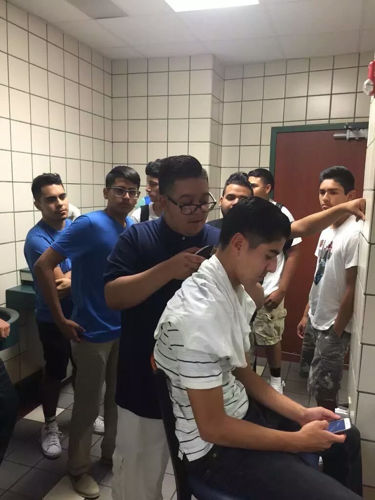 @ Friend in high school sent me this pic after he got done taking a shit and saw all these guys in the bathroom waiting to get a haircut by another kid.@@@