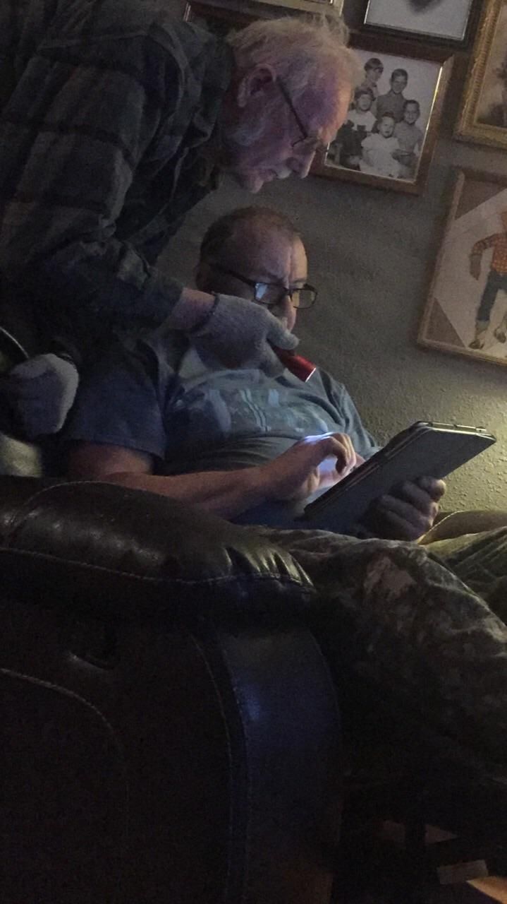 My uncle using his flashlight to brighten up my dads iPad screen