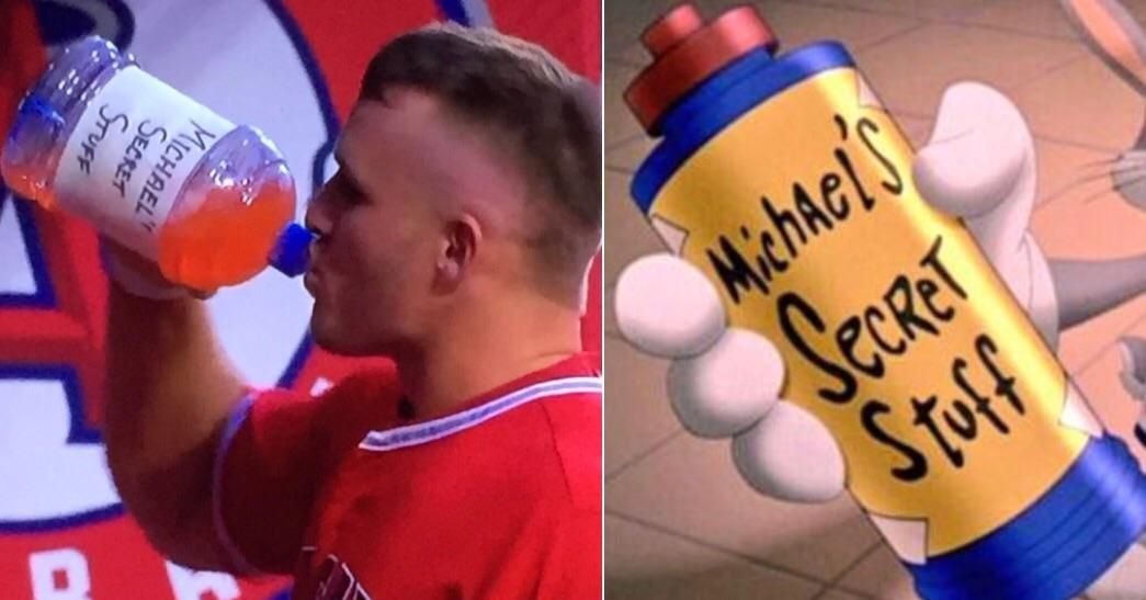 Mike Trout in the dugout drinking out of a Space Jam Inspired bottle.