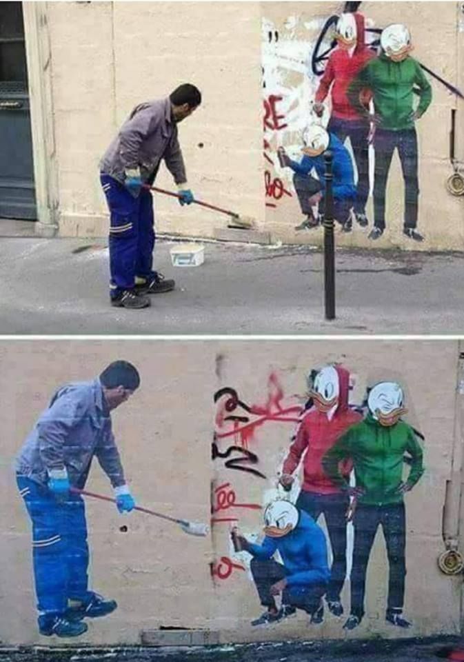 A worker removed the graffiti , the artist returned and painted it and drew the worker as he wiped it
