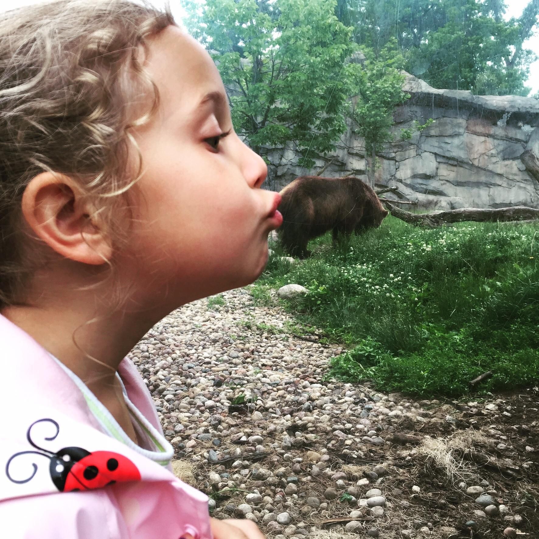 I told my daughter to pretend she was kissing the bear at the zoo.....