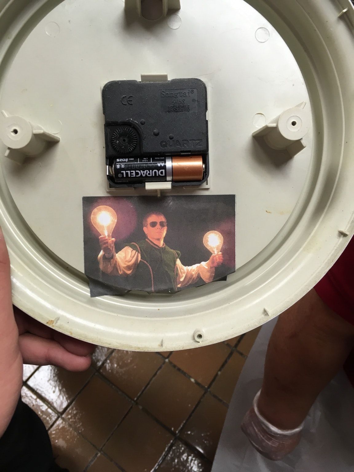 A co-worker posted pictures of himself in random places when he quit. This is the back of a clock, and he quit 2 years ago.