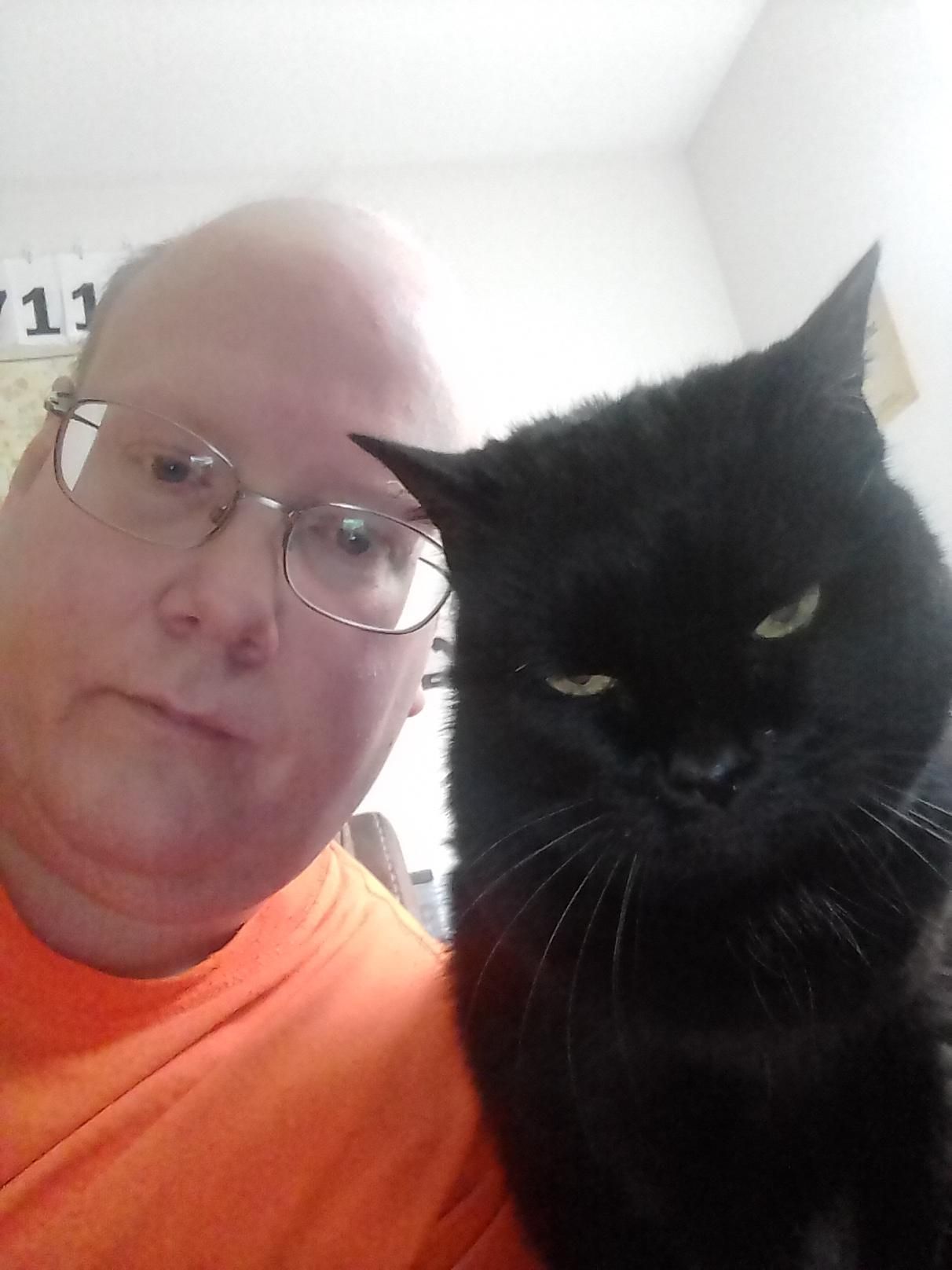 I tried to take a selfie with my cat, but now it looks like we're about to drop a new album.