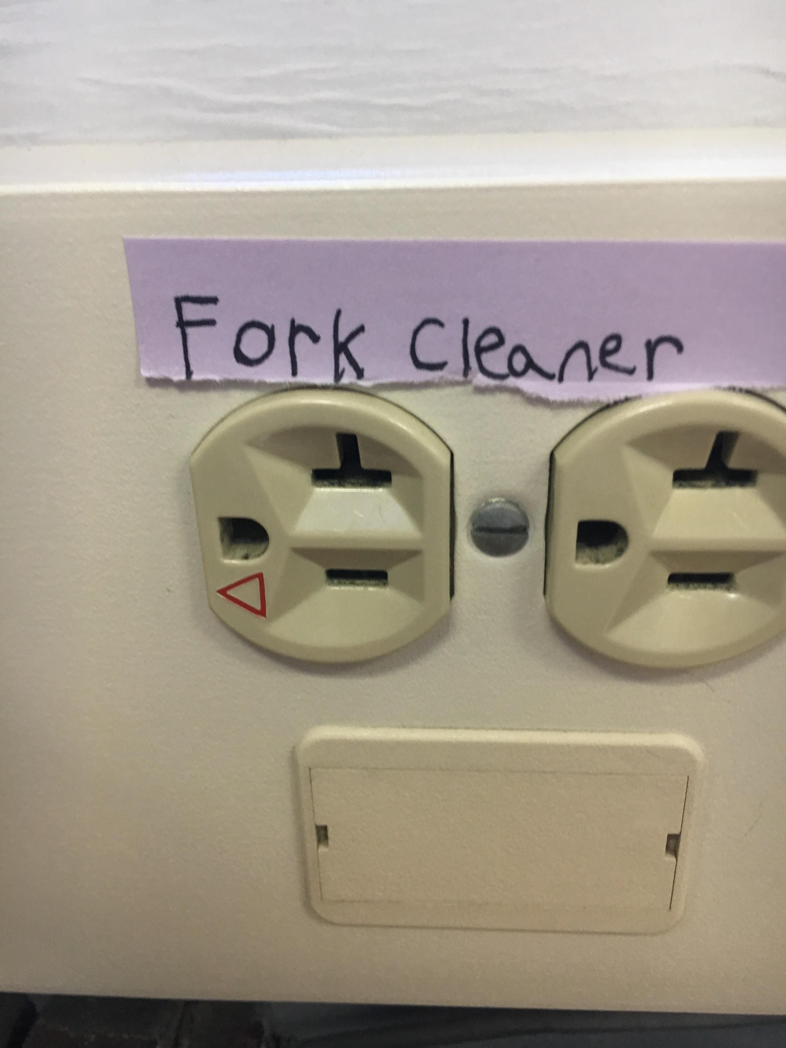 Someone put a helpful label on the electrical outlet at school.