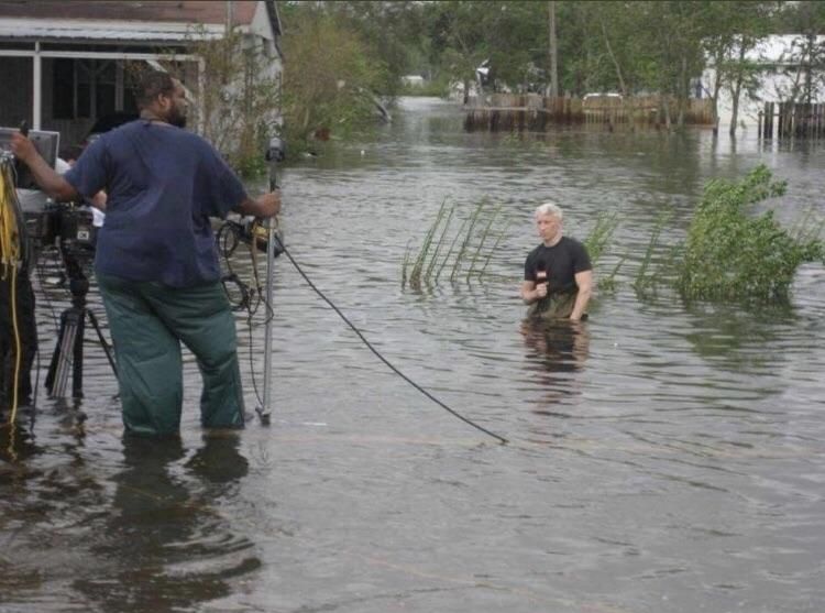 News: “There’s not too much flooding here”. Reporter: “I could get on my knees”. News: “Perfect”.