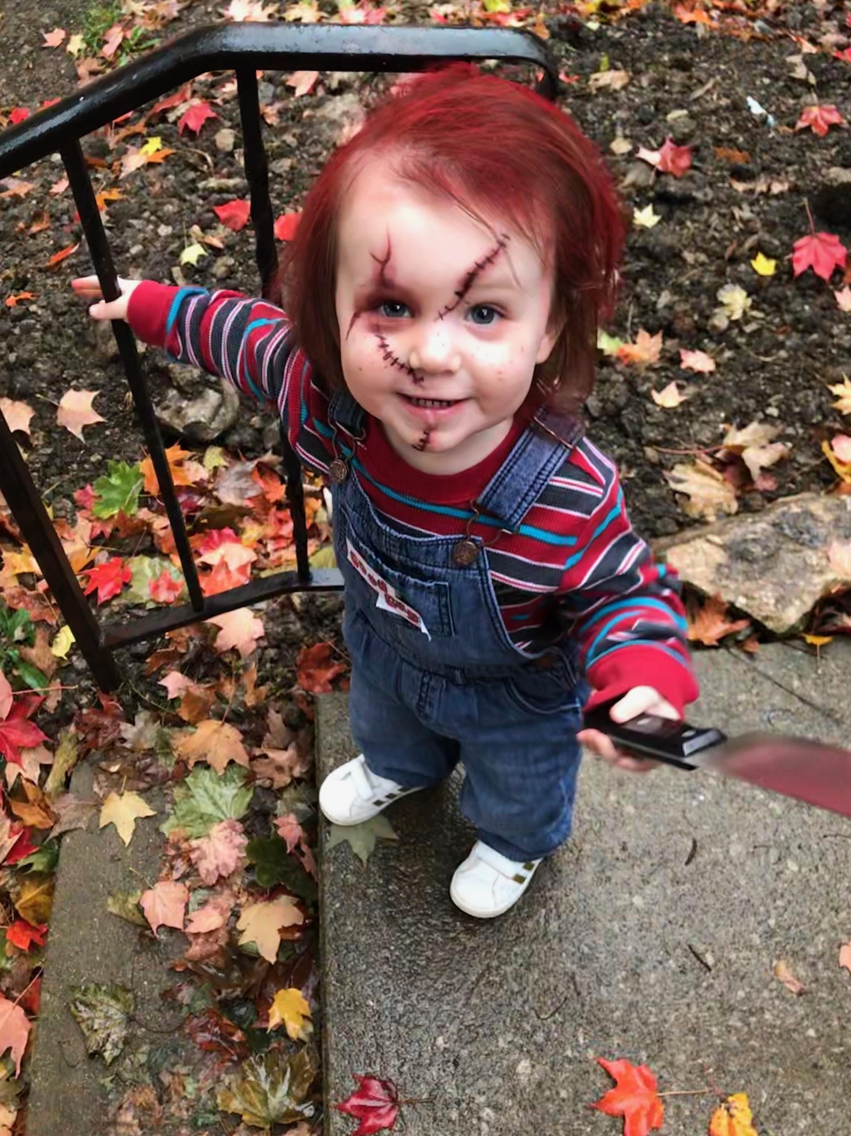 Our two year old daughter. Because when big sis wants to dress up as Jason Voorhees, what better side kick than Chucky?
