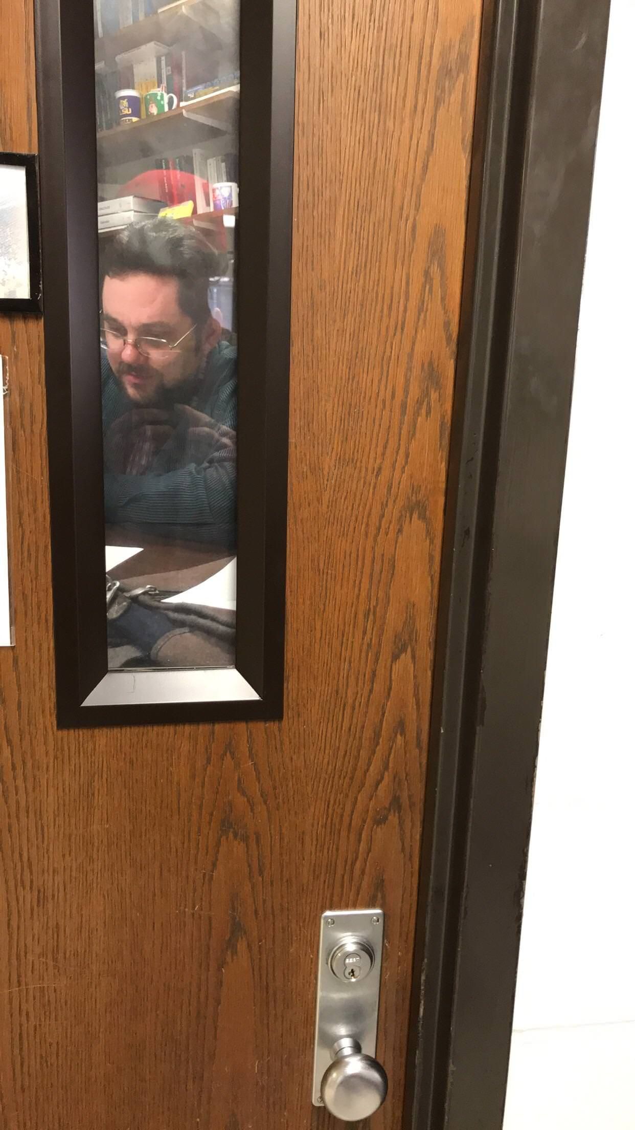 Teacher put up a picture of himself on his door so it looks like he’s always in his office.