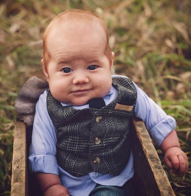 This baby looks like he’s ready to pour you a pint at his pub.