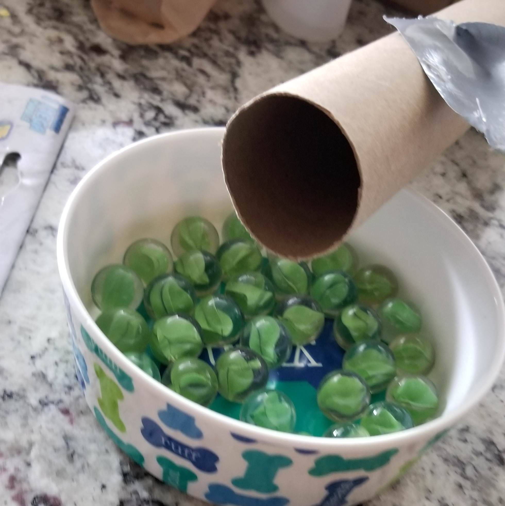 Because my wife likes to shake presents when I'm away, I'm putting a cardboard tube full of marbles in with her gift.