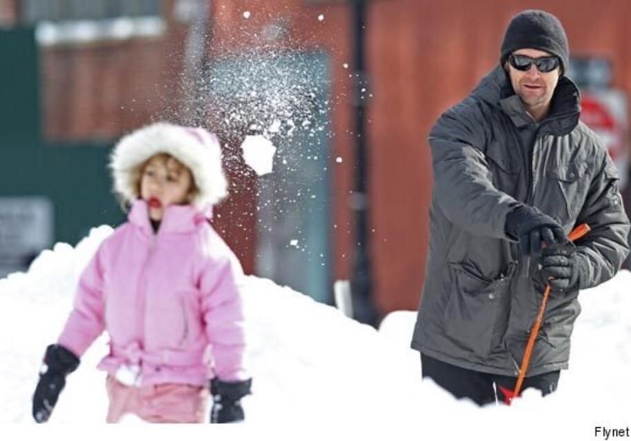 Hugh Jackman chucks snowball at daughter.