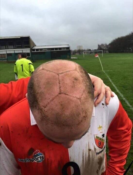 bald man hit in the head by soccer ball