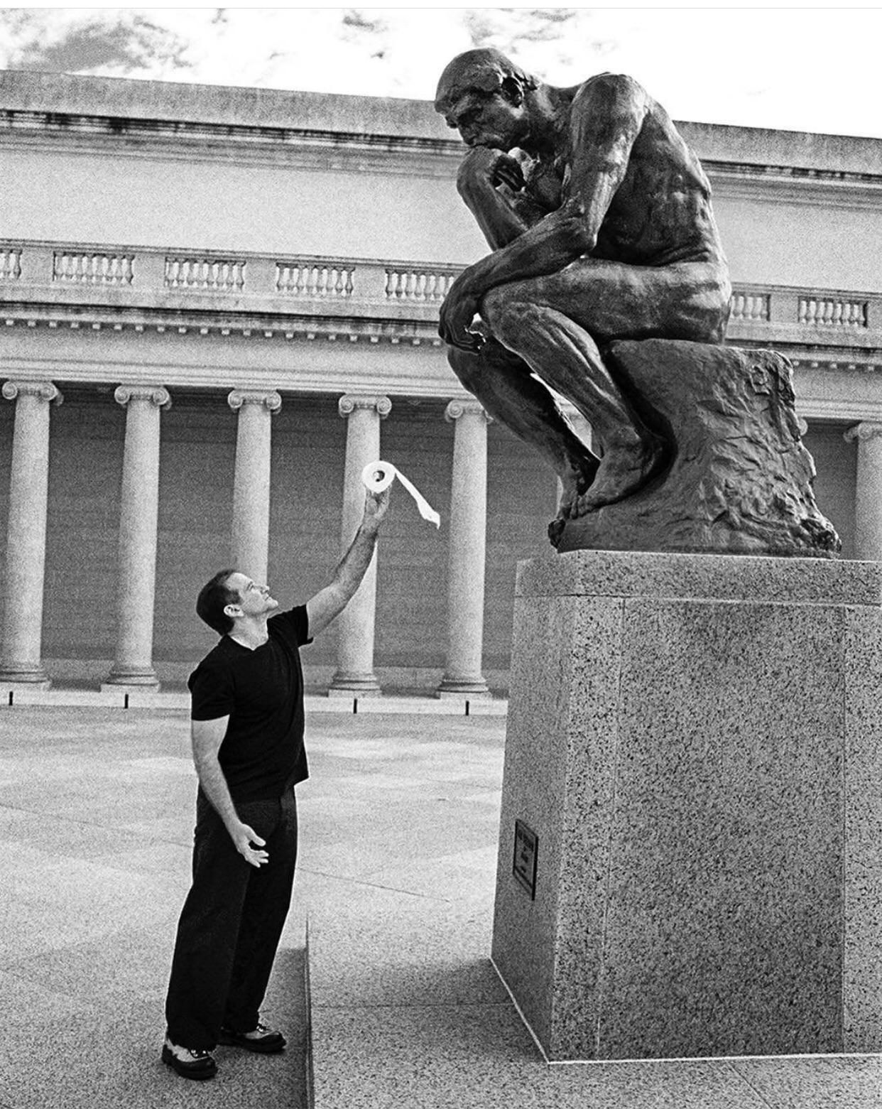Robin Williams offering a toilet roll to ’ The Thinker’